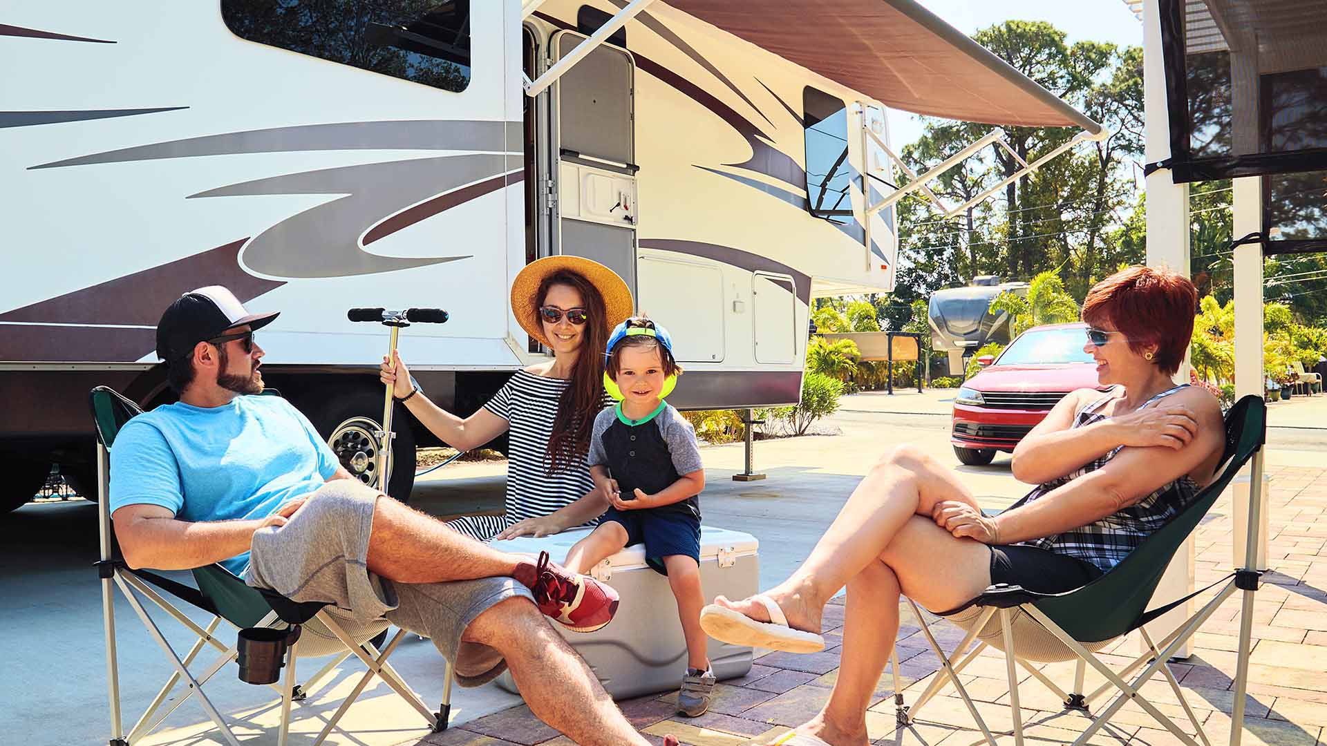 Family spending time together outside of parked RV