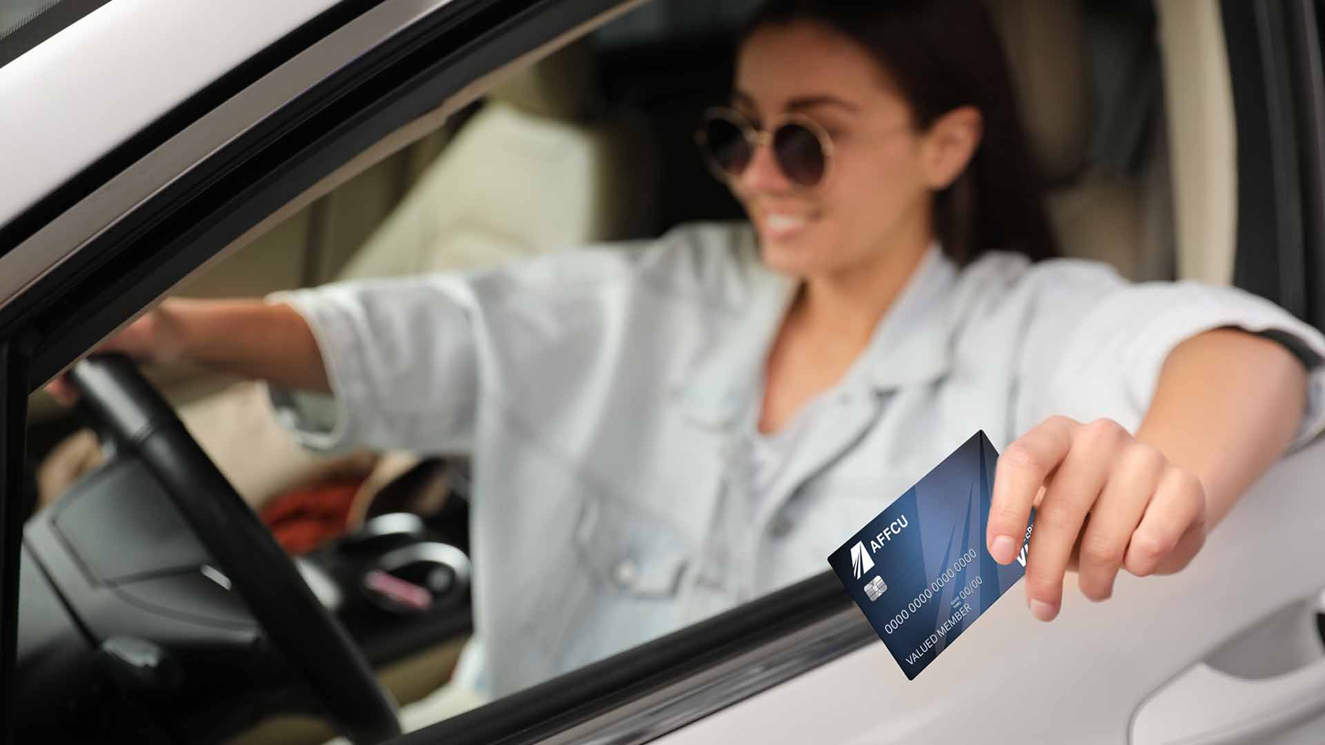 Woman in car with debit card