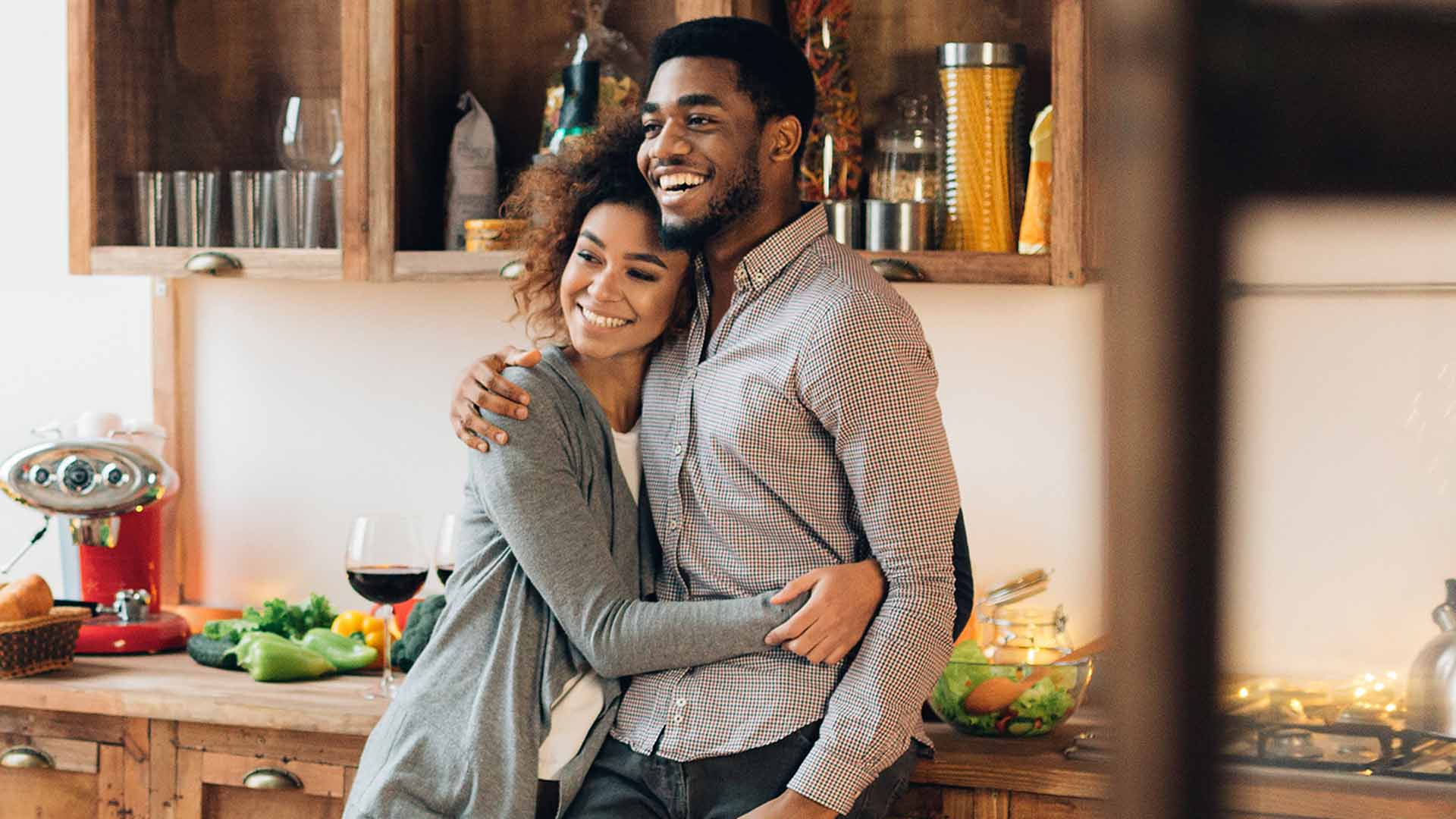 Young couple embracing in kitchen