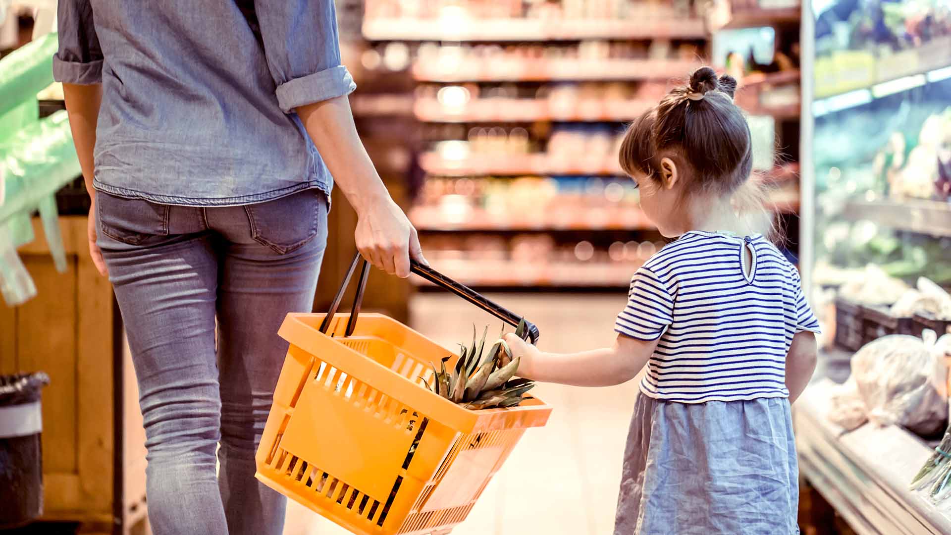 Young girl shopping with parent